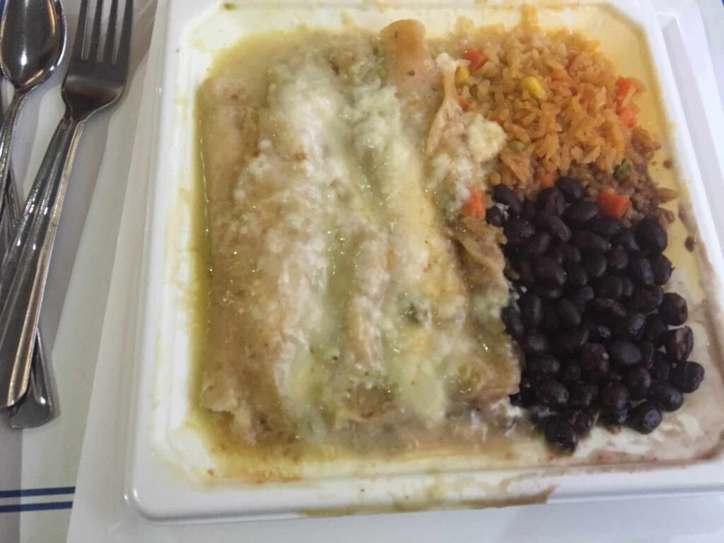 An enchilada meal with beans and rice.