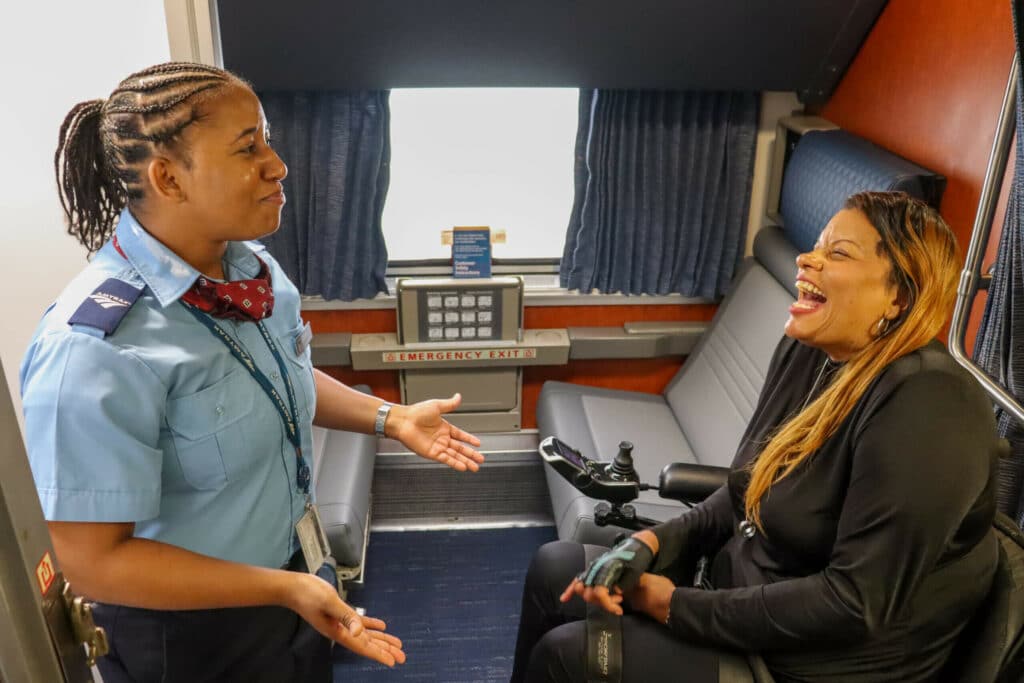 Amtrak Car attendant and passenger in a Amtrak accessible room.