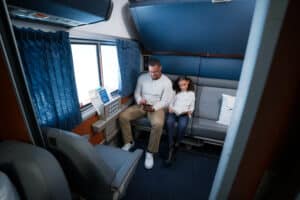 Two people in an Amtrak bedroom