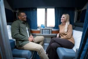 Two people sitting in an Amtrak Superliner roomette