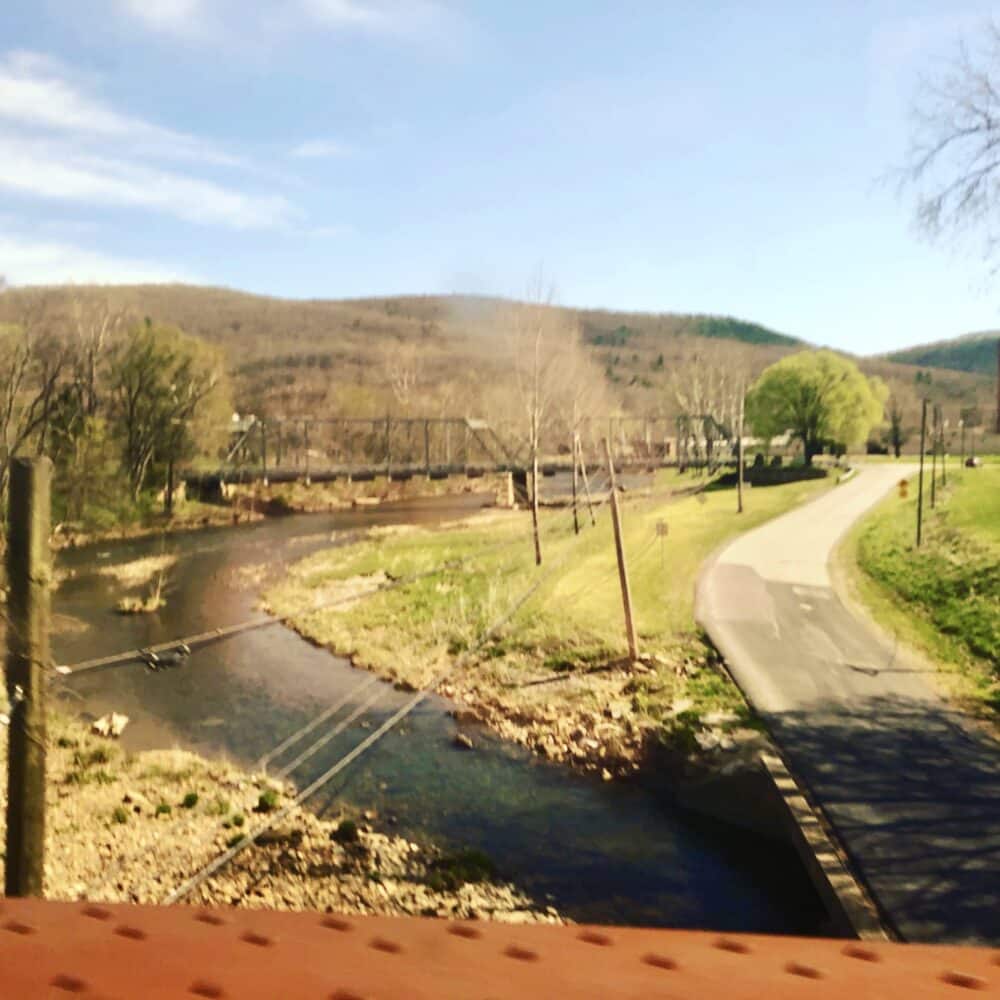 A river and road view from the train.