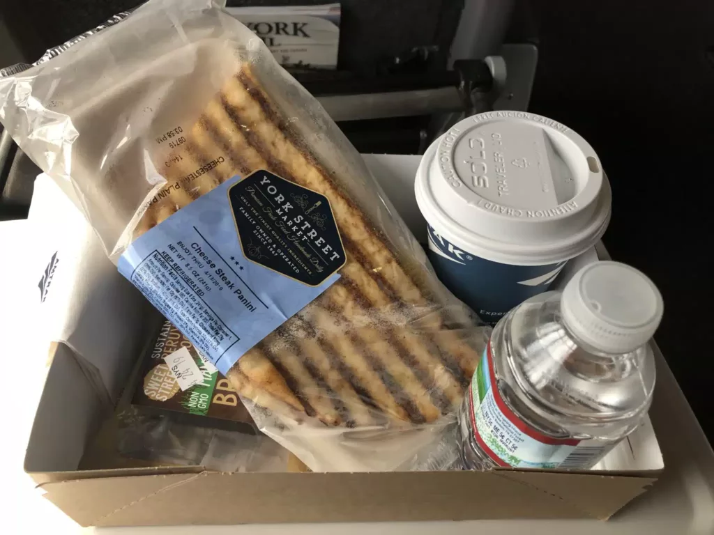 A sandwisch, coffee, water, and brownie from an Amtrak cafe car.
