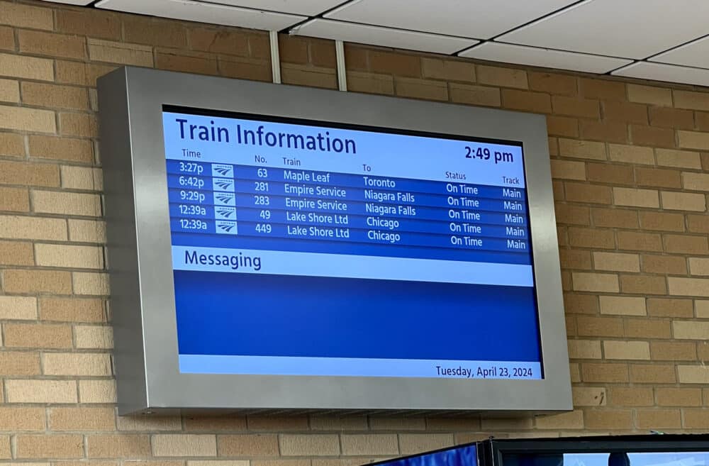 A screen telling people the upcoming trains so.
