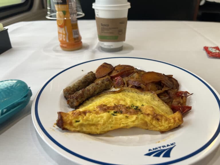 Amtrak flex dining omelette on a plate with potatoes and sausage.